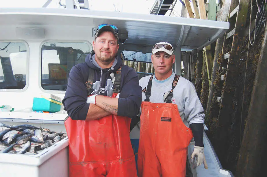 Two of Luke’s east coast fisherman garnering their daily catch on the water, photo courtesy of Luke’s Lobsters.