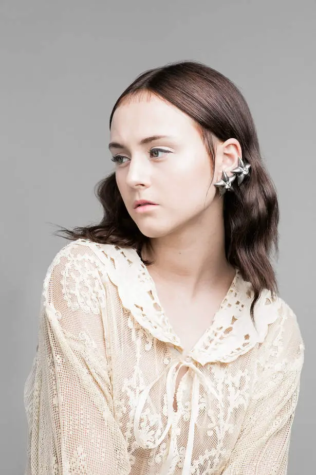 Jenna is wearing a Vintage Cream Sheer Lace Dropwaist Dress and Vintage Mexican Silver Star Earrings.