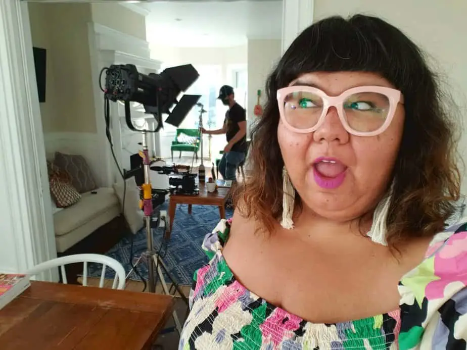Photo of Virgie Tovar on-set. In 2018 she was named one of the 50 most influential feminists by Bitch Magazine. She has received two San Francisco Arts Commission Individual Artist Commissions as well as  Yale's Poynter Fellowship in Journalism .