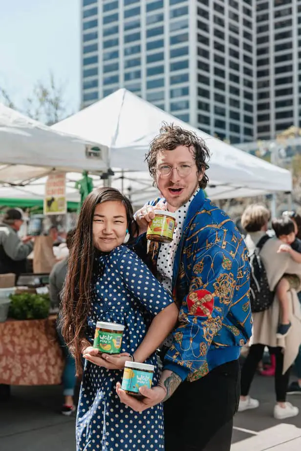 The duo holding their Ugly Pickle Co. creations at the Ferry Building farmers market.